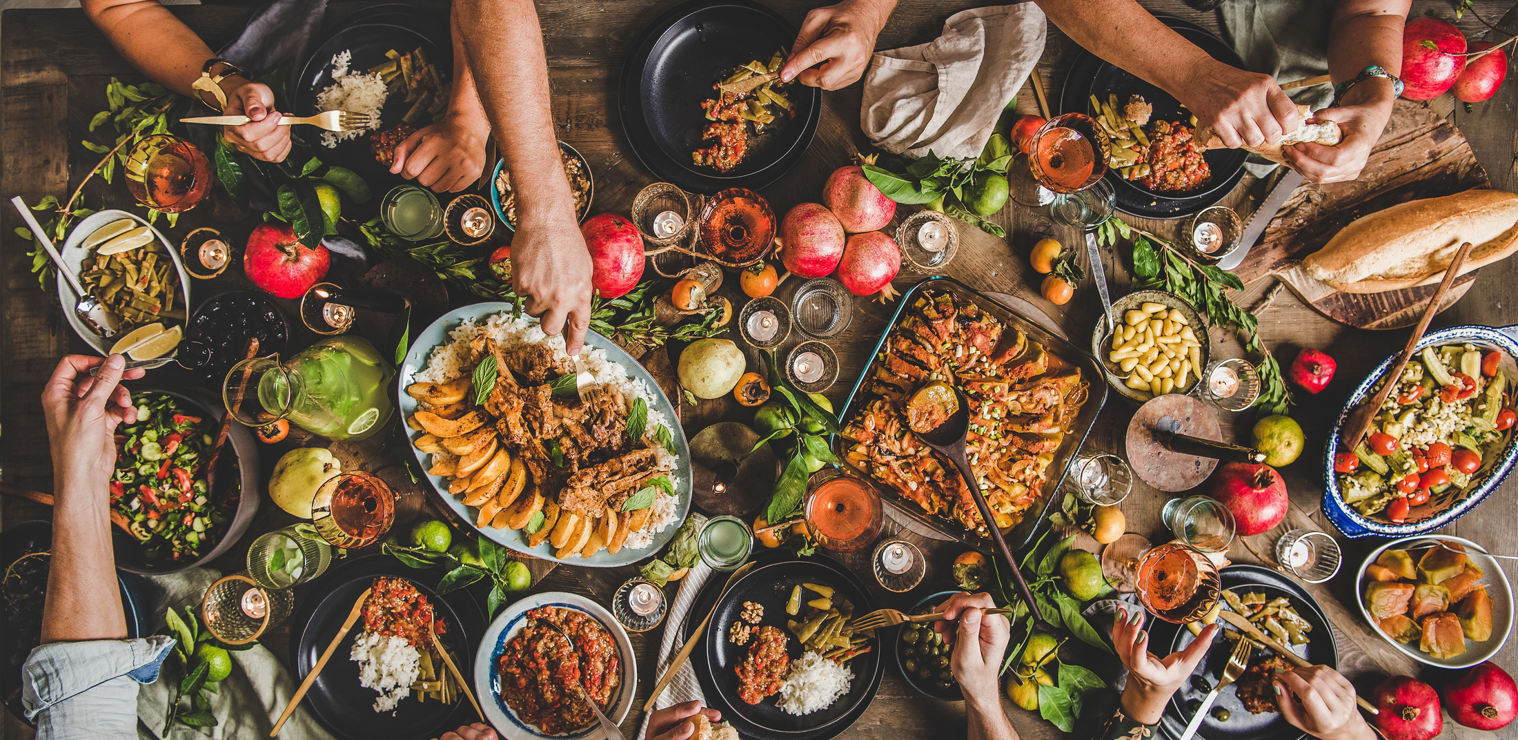 Flat-lay of family feasting with Turkish cuisine foods, wide composition